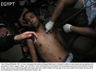Tara Todras-Whitehill / AP - A man, who gave his name as Maged Mahmoud, is tended to after he was injured during clashes w...
