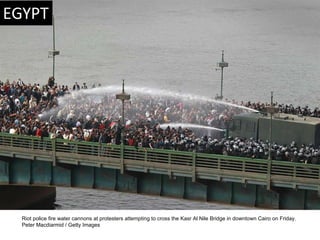 Riot police fire water cannons at protesters attempting to cross the Kasr Al Nile Bridge in downtown Cairo on Friday.  Pet...