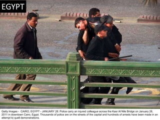 Getty Images -  CAIRO, EGYPT - JANUARY 28: Police carry an injured colleague across the Kasr Al Nile Bridge on January 28,...