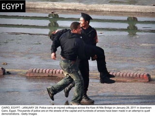 CAIRO, EGYPT - JANUARY 28: Police carry an injured colleague across the Kasr Al Nile Bridge on January 28, 2011 in downtow...