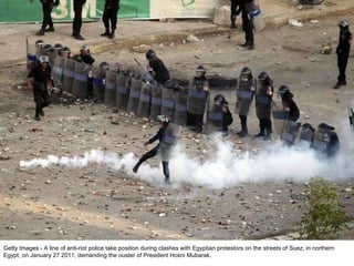 Getty Images - A line of anti-riot police take position during clashes with Egyptian protestors on the streets of Suez, in...
