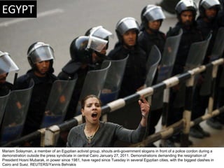 Mariam Solayman, a member of an Egyptian activist group, shouts anti-government slogans in front of a police cordon during...