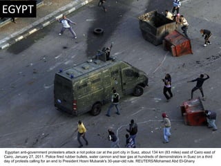   Egyptian anti-government protesters attack a riot police car at the port city in Suez, about 134 km (83 miles) east of C...