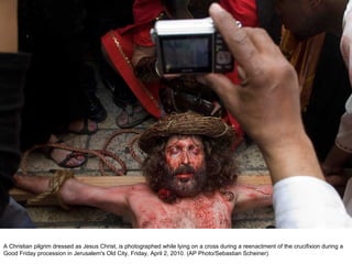 A Christian pilgrim dressed as Jesus Christ, is photographed while lying on a cross during a reenactment of the crucifixion during a Good Friday procession in Jerusalem's Old City, Friday, April 2, 2010. (AP Photo/Sebastian Scheiner)  
