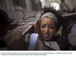 A Christian Ethiopian pilgrim holds a cross during Good Friday processions along Via Dolorosa, in Jerusalem's Old City, Friday. Christians are marking the solemn period of Easter. (AP Photo/Bernat Armangue)  