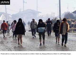 People walk on a muddy road as they evacuate to a shelter in Natori city, Miyagi prefecture on March 12. (AFP/Getty Images  