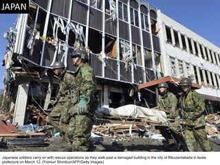 Japanese soldiers carry on with rescue operations as they walk past a damaged building in the city of Rikuzentakada in Iwate prefecture on March 12. (Yomiuri Shimbun/AFP/Getty Images)  