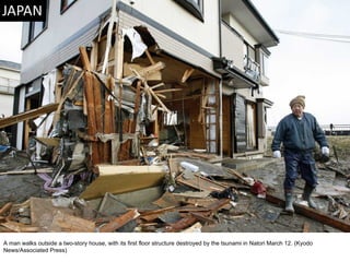A man walks outside a two-story house, with its first floor structure destroyed by the tsunami in Natori March 12. (Kyodo News/Associated Press)  