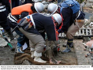 Rescue workers lift the body of a victim from the rubble in Rikuzentakata, northern Japan after the magnitude 8.9 earthquake and tsunami struck the area, March 13, 2011. (REUTERS/Toru Hanai  