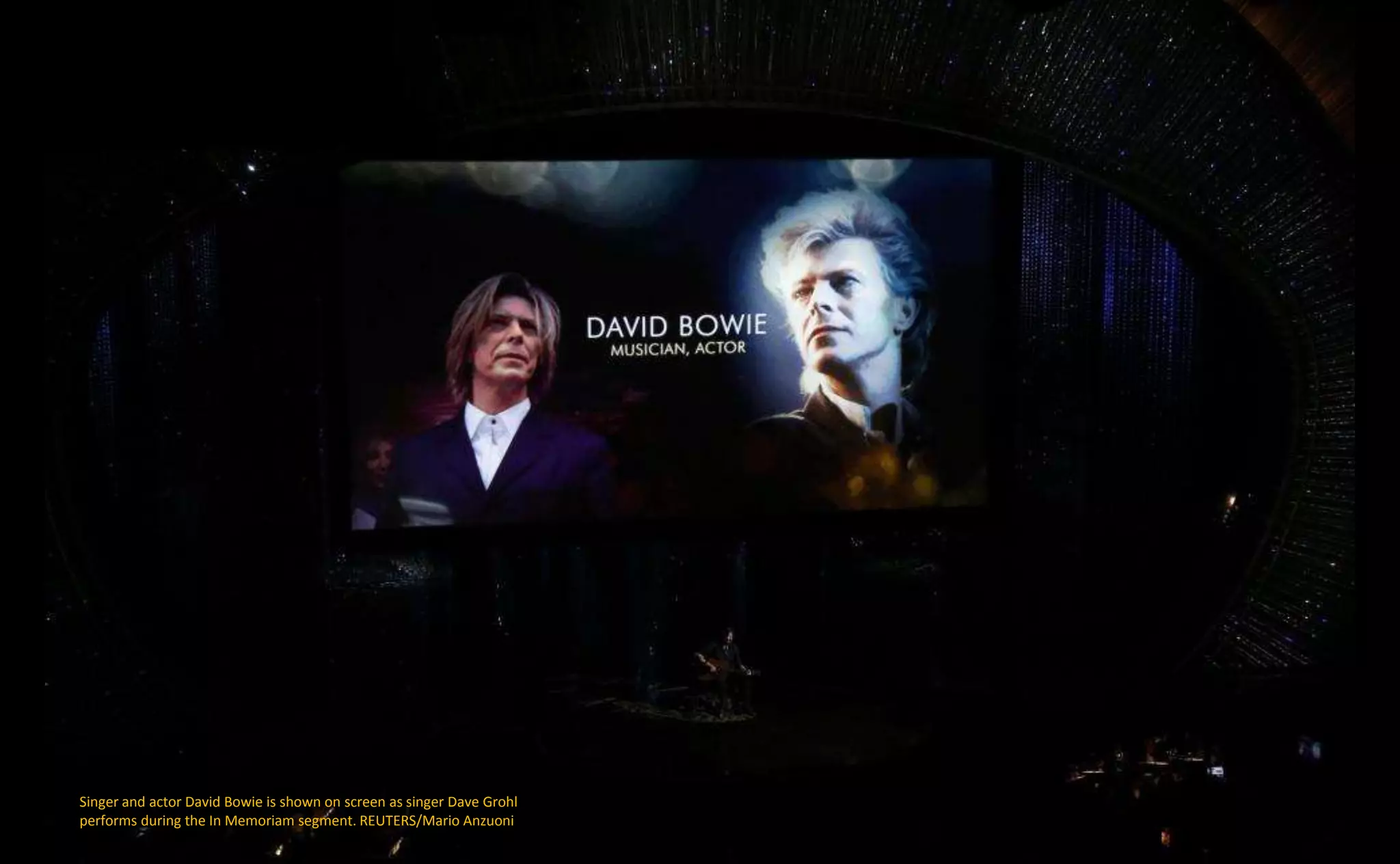 Singer and actor David Bowie is shown on screen as singer Dave Grohl
performs during the In Memoriam segment. REUTERS/Mario Anzuoni
 