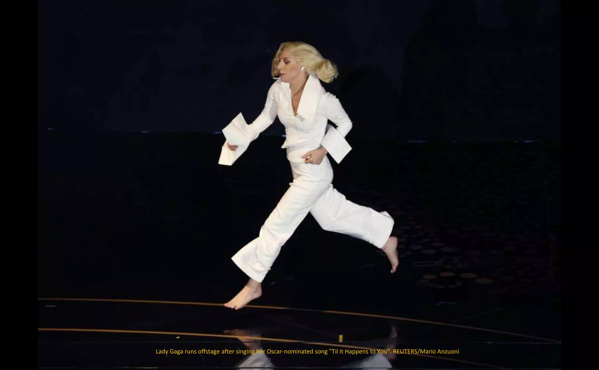 Lady Gaga runs offstage after singing her Oscar-nominated song "Til It Happens to You". REUTERS/Mario Anzuoni
 