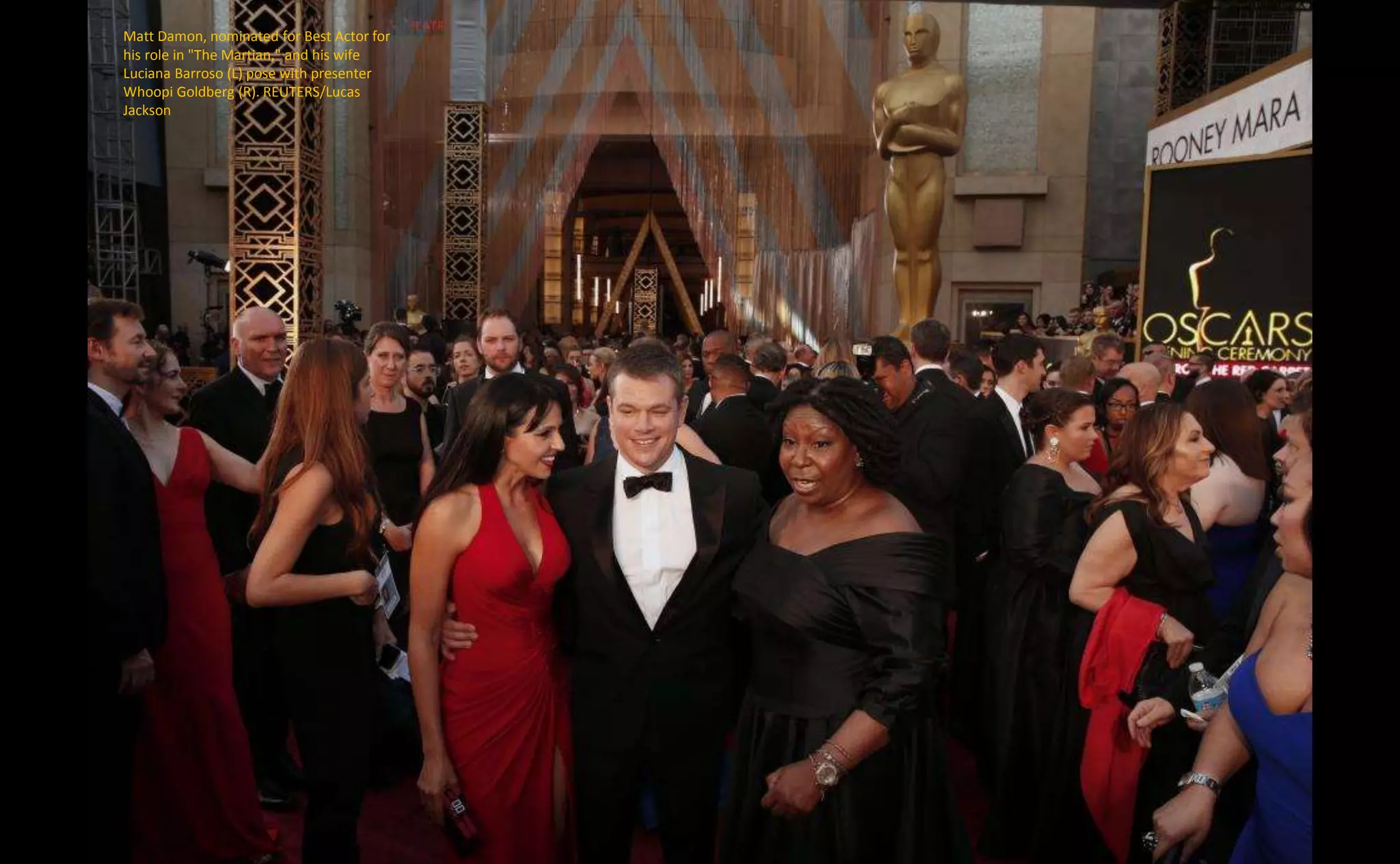Matt Damon, nominated for Best Actor for
his role in "The Martian," and his wife
Luciana Barroso (L) pose with presenter
Whoopi Goldberg (R). REUTERS/Lucas
Jackson
 