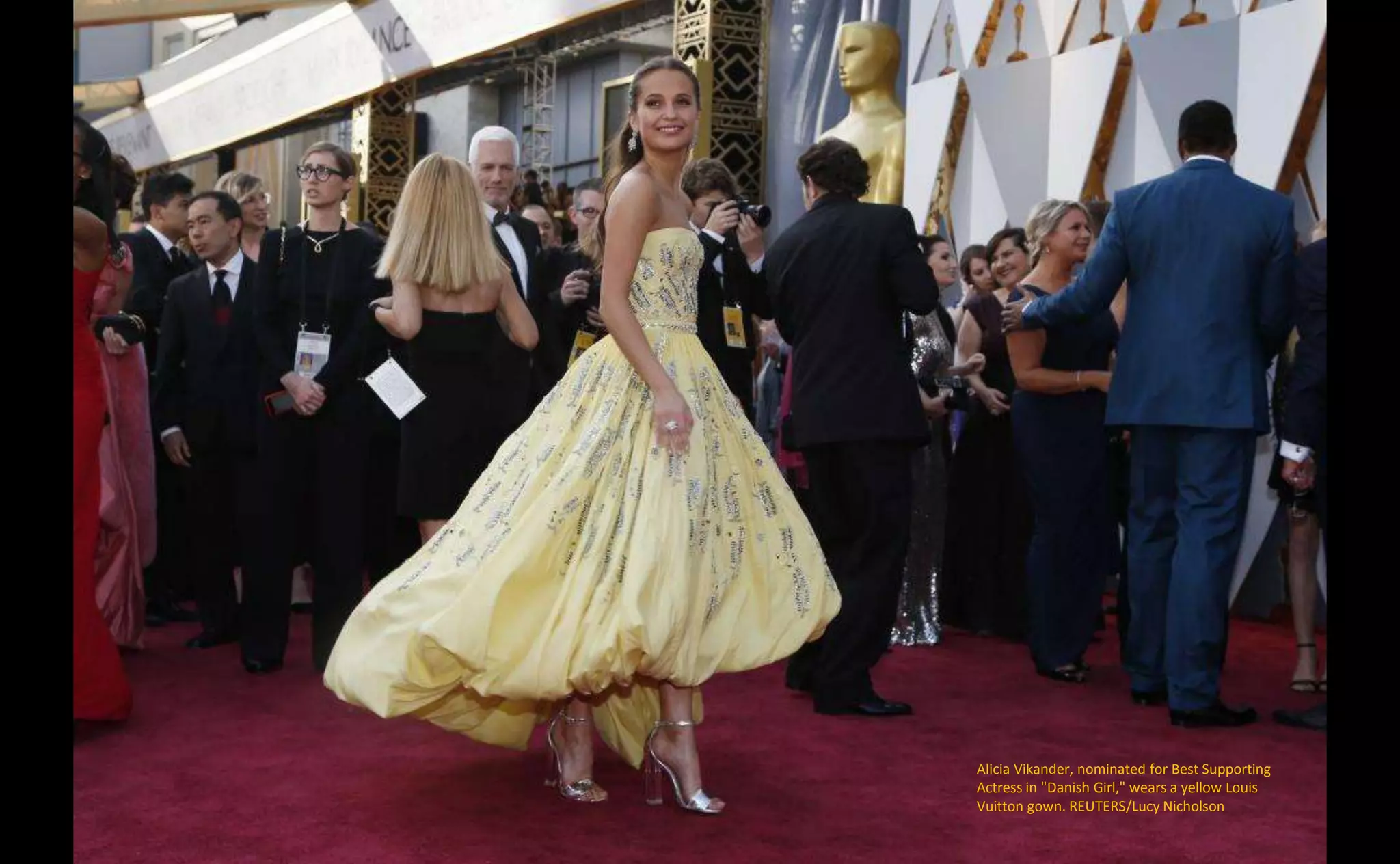 Alicia Vikander, nominated for Best Supporting
Actress in "Danish Girl," wears a yellow Louis
Vuitton gown. REUTERS/Lucy Nicholson
 