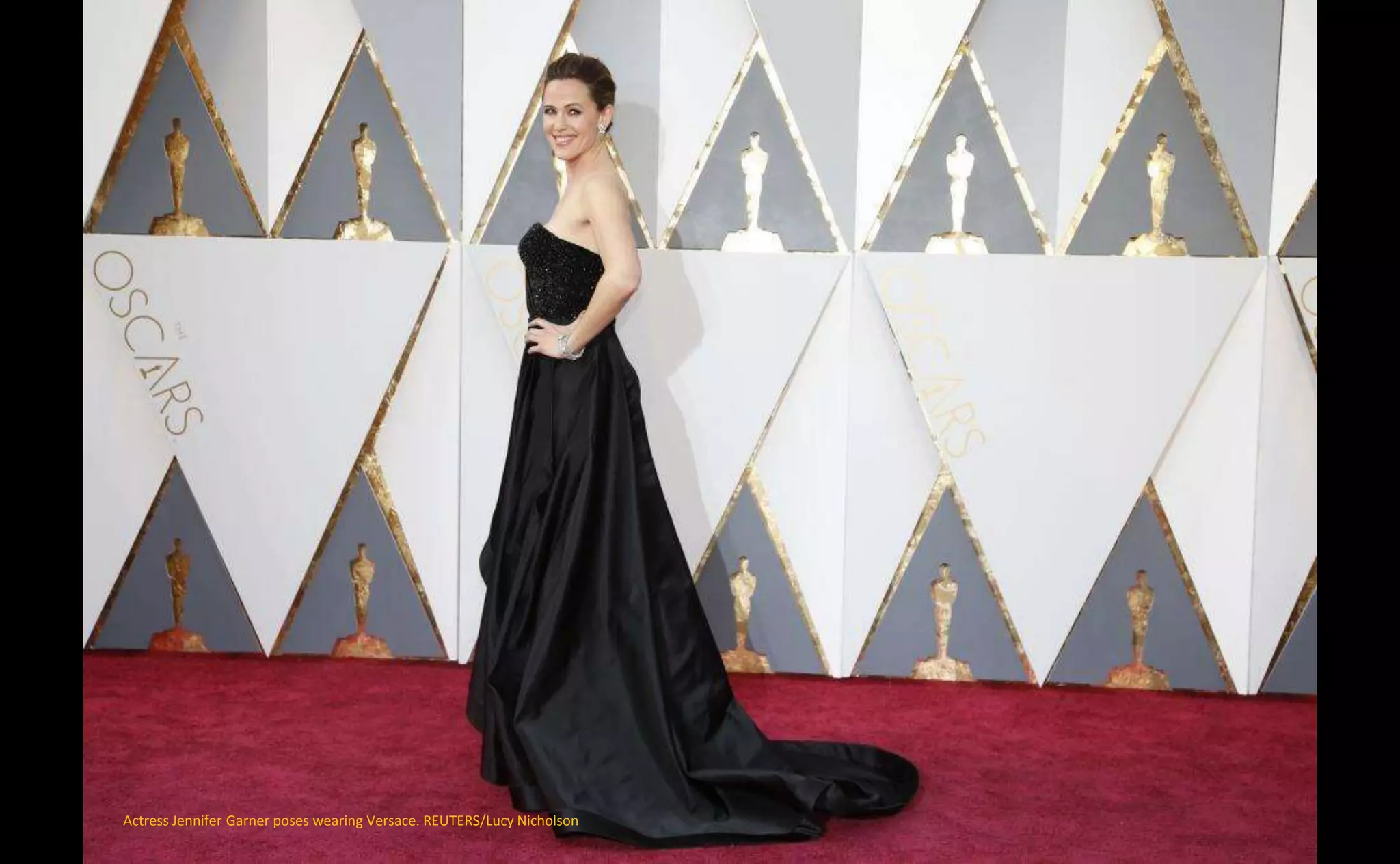 Actress Jennifer Garner poses wearing Versace. REUTERS/Lucy Nicholson
 