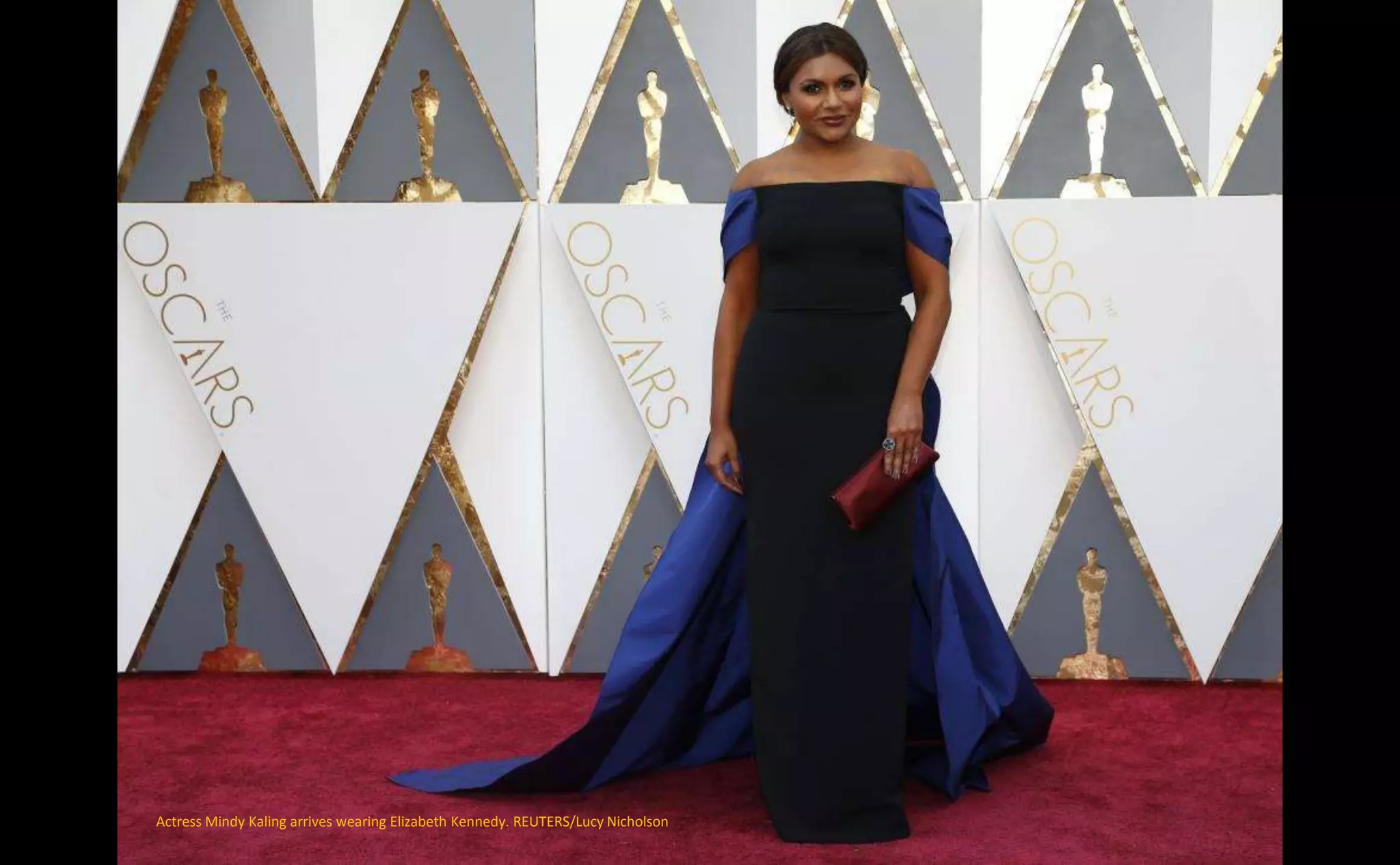 Actress Mindy Kaling arrives wearing Elizabeth Kennedy. REUTERS/Lucy Nicholson
 