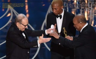 Ennio Morricone (left) accepts the award for best
original score, for The Hateful Eight, from producer
Quincy Jones (right) and Pharrell Williams. Mark
Ralston/AFP/Getty Images
 