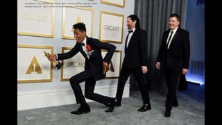 Jon Batiste, Trent Reznor and Atticus Ross, winners of the award for best
original score for "Soul" arrive in the press room. Chris Pizzello/Pool
 