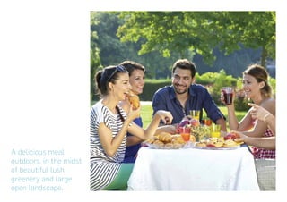 A delicious meal
outdoors, in the midst
of beautiful lush
greenery and large
open landscape.
 
