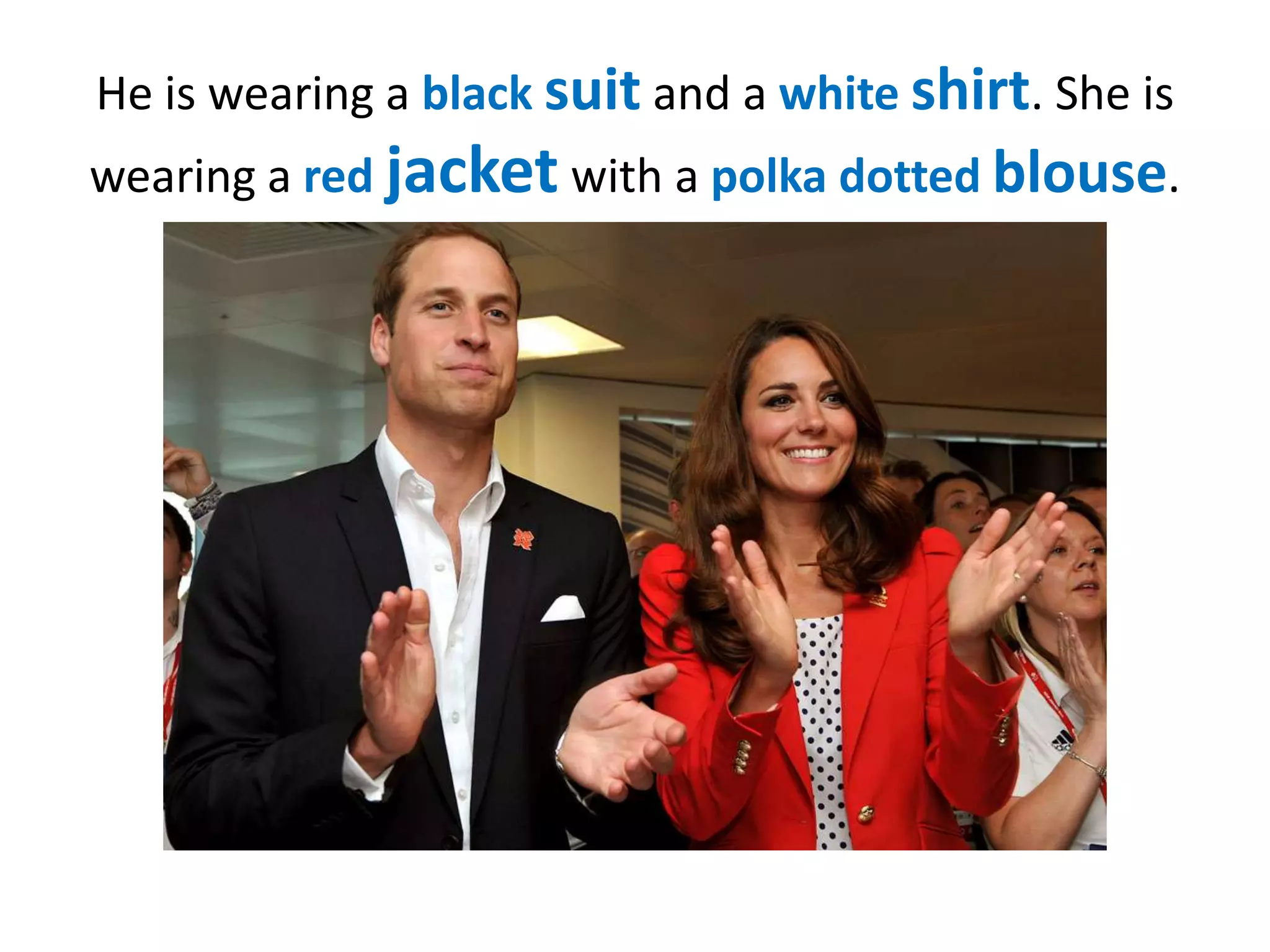 He is wearing a black suit and a white shirt. She is
wearing a red jacket with a polka dotted blouse.

 
