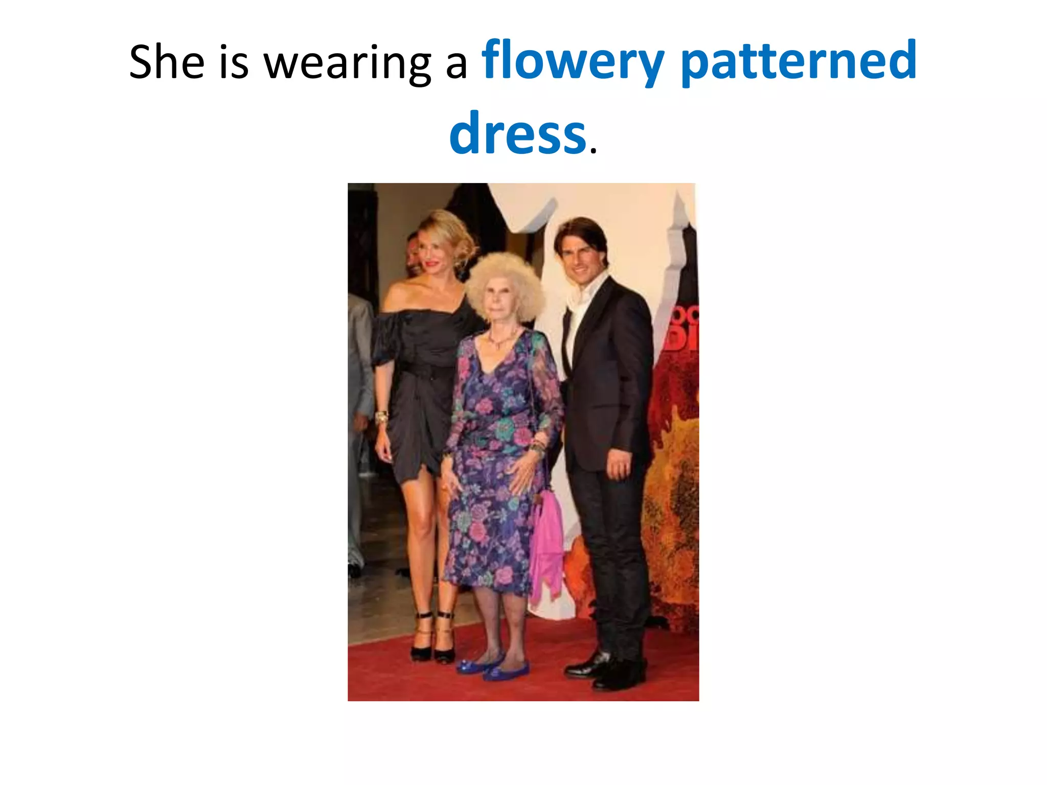 She is wearing a flowery patterned

dress.

 