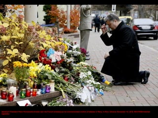 A woman places a flower, in sympathy with the victims of the Paris attacks, in front of the French embassy in Rome, Italy ...