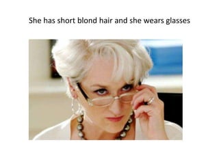 She has short blond hair and she wears glasses
 