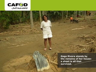 Gaga Rivera stands by the remains of her house: a sheet is all that survived.  