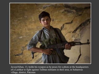 Javeed Khan, 13, holds his weapon as he poses for a photo at the headquarters of a Lashkar to fight against Taliban militants in their area, in Sultanwas village, district, Pakistan 