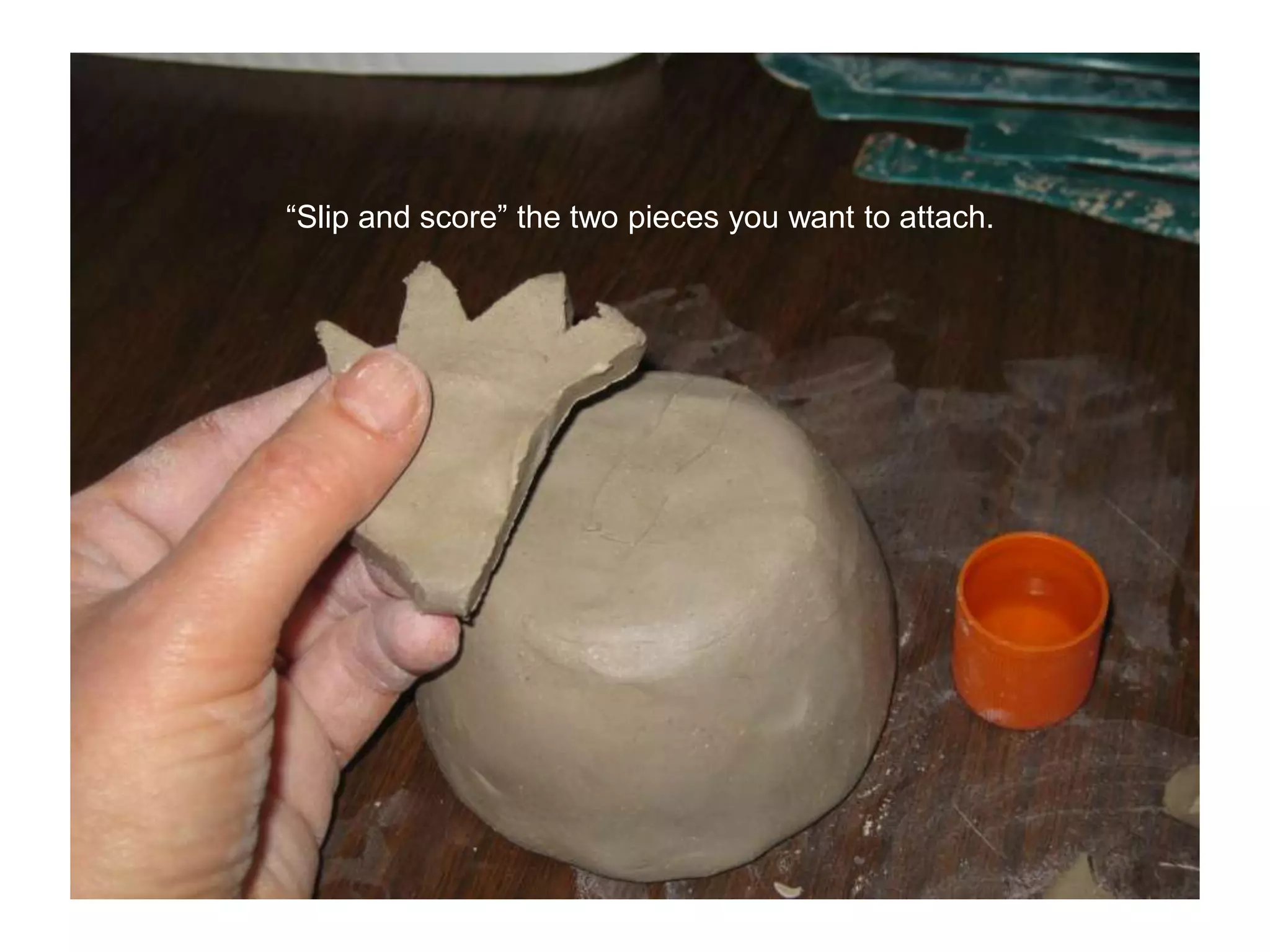 “Slip and score” the two pieces you want to attach.