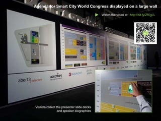 Agenda for Smart City World Congress displayed on a large wall

                                             Watch the video at: http://bit.ly/ZfXgLL




Visitors collect the presenter slide decks
                  and speaker biographies
 