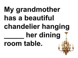 My grandmother has a beautiful chandelier hanging _____ her dining room table.