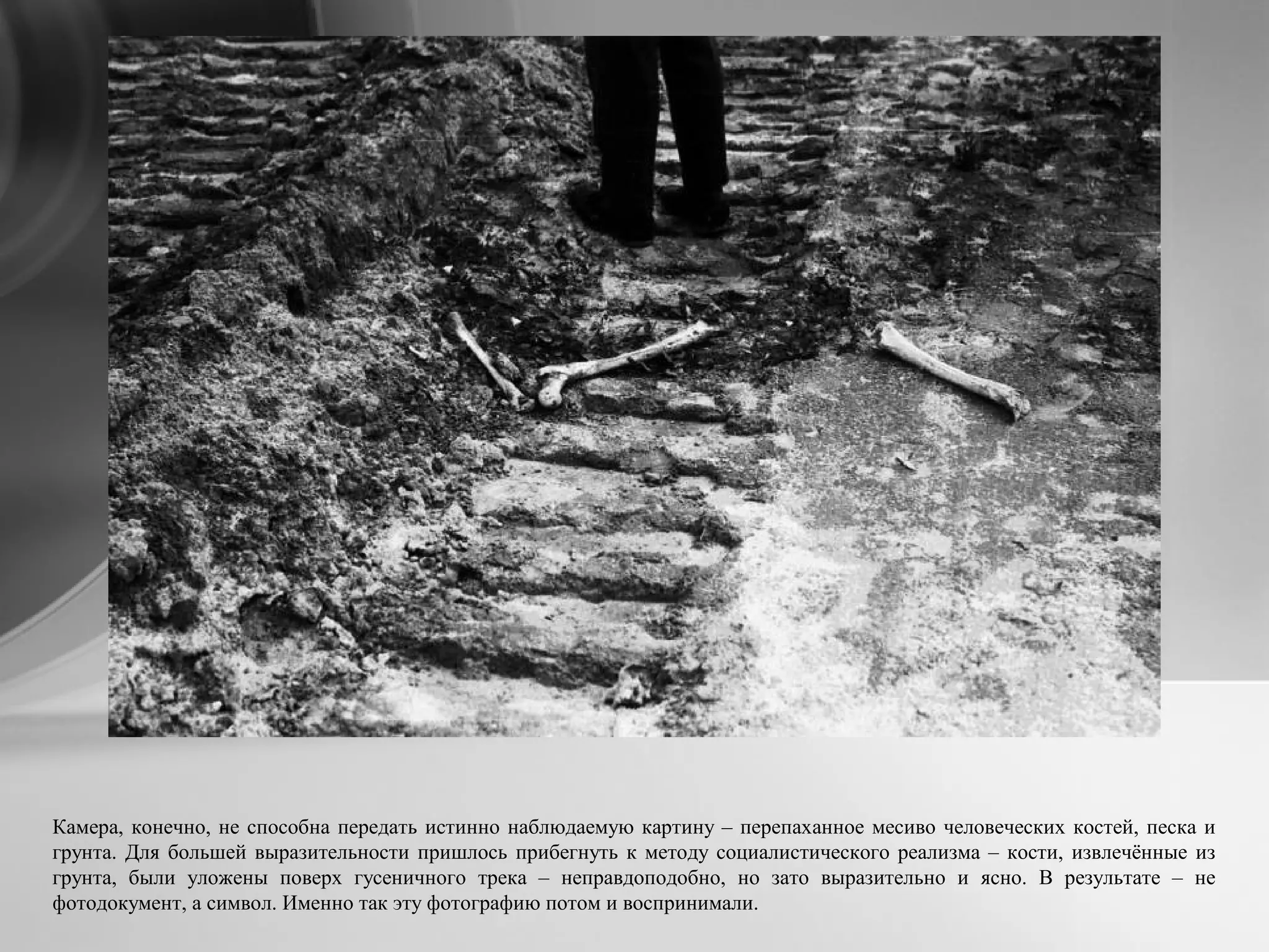 Камера, конечно, не способна передать истинно наблюдаемую картину – перепаханное месиво человеческих костей, песка и
грунта. Для большей выразительности пришлось прибегнуть к методу социалистического реализма – кости, извлечённые из
грунта, были уложены поверх гусеничного трека – неправдоподобно, но зато выразительно и ясно. В результате – не
фотодокумент, а символ. Именно так эту фотографию потом и воспринимали.
 