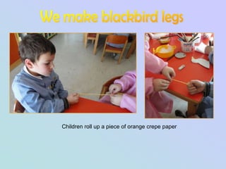 Children roll up a piece of orange crepe paper
 