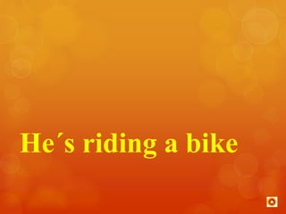 He´s riding a bike 
 