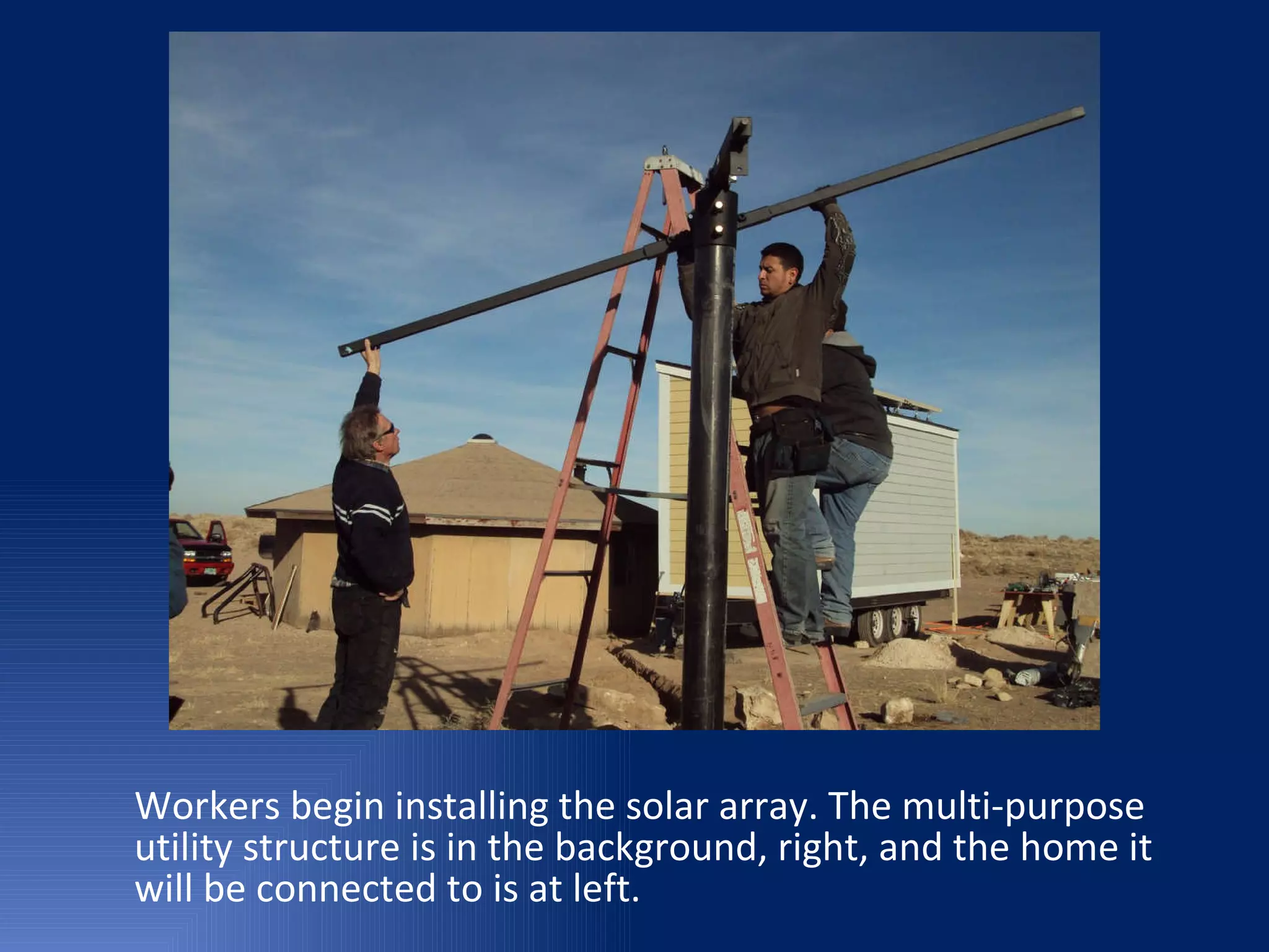 Workers begin installing the solar array. The multi-purpose utility structure is in the background, right, and the home it will be connected to is at left. 