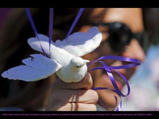 Holds a fabric dove at the base of balloons as she pays tribute at a makeshift memorial outside the fence of Paisley Park in Chanhassen, Minnesota. REUTERS/Eric Miller
 