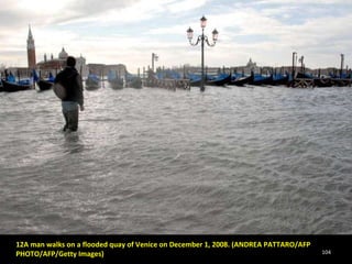 12A man walks on a flooded quay of Venice on December 1, 2008. (ANDREA PATTARO/AFP PHOTO/AFP/Getty Images)  