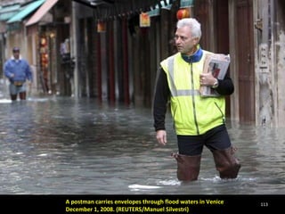 A postman carries envelopes through flood waters in Venice  December 1, 2008. (REUTERS/Manuel Silvestri)  