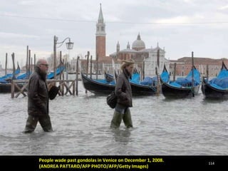 People wade past gondolas in Venice on December 1, 2008.  (ANDREA PATTARO/AFP PHOTO/AFP/Getty Images) 