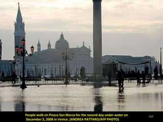 People walk on Piazza San Marco for the second day under water on December 2, 2008 in Venice. (ANDREA PATTARO/AFP PHOTO)  