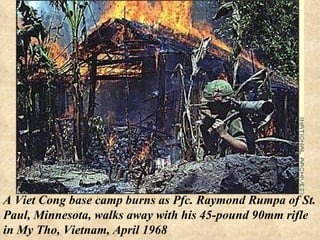 A Viet Cong base camp burns as Pfc. Raymond Rumpa of St. Paul, Minnesota, walks away with his 45-pound 90mm rifle in My Tho, Vietnam, April 1968 