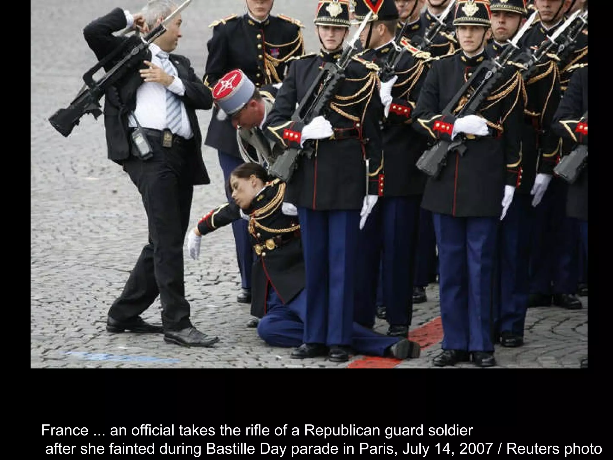 France ... an official takes the rifle of a Republican guard soldier after she fainted during Bastille Day parade in Paris, July 14, 2007 / Reuters photo  