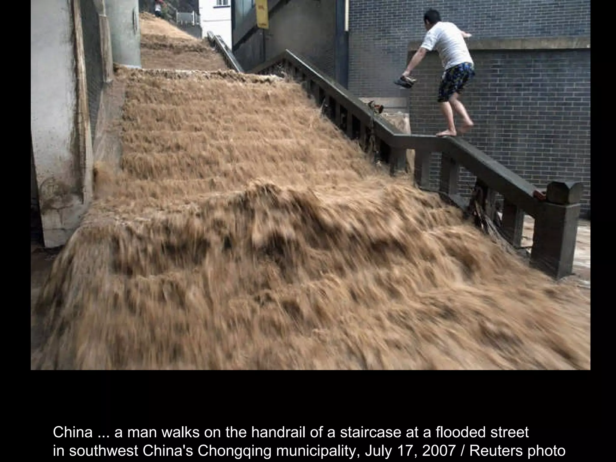 China ... a man walks on the handrail of a staircase at a flooded street  in southwest China's Chongqing municipality, July 17, 2007 / Reuters photo  