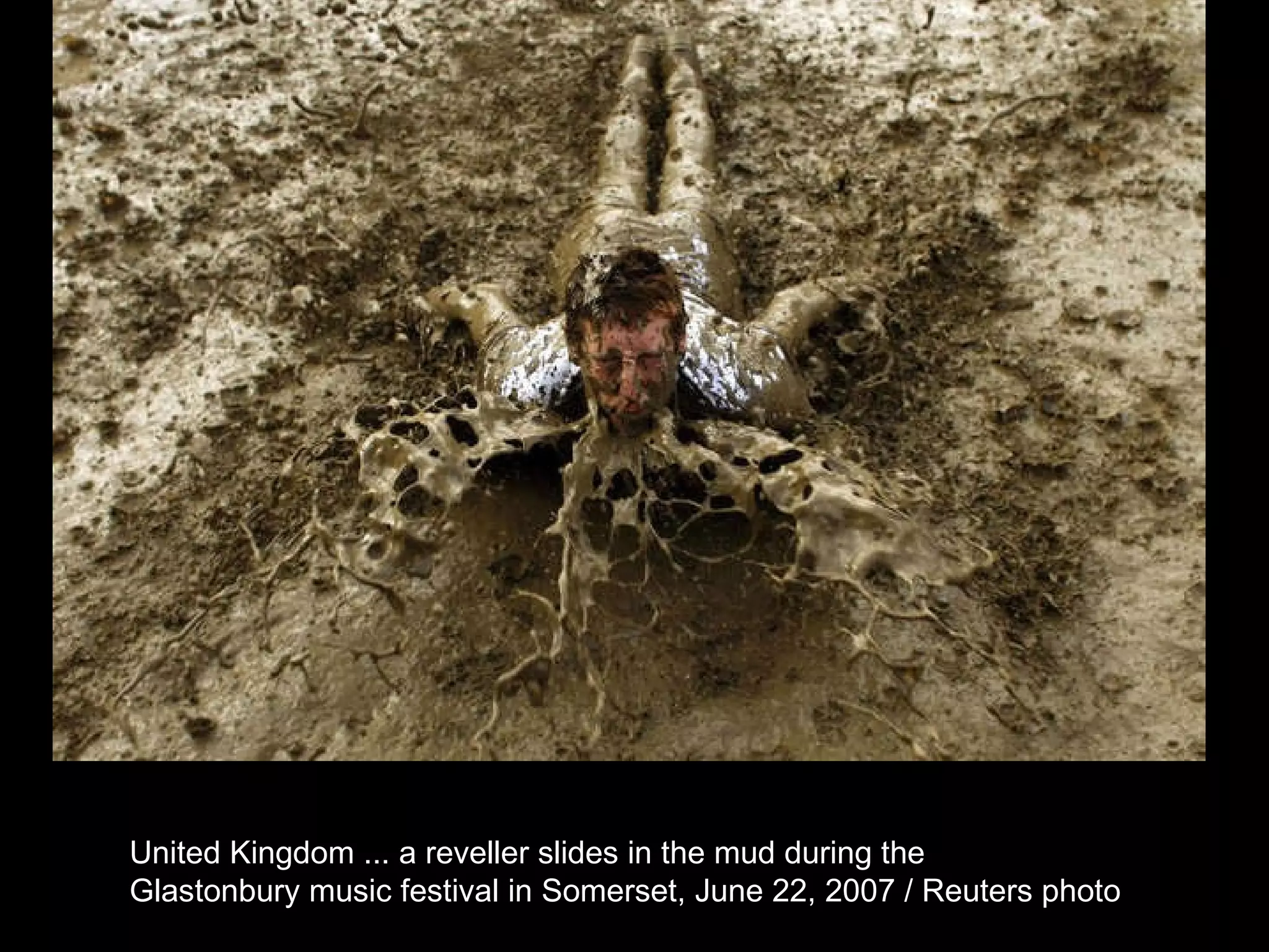 United Kingdom ... a reveller slides in the mud during the  Glastonbury music festival in Somerset, June 22, 2007 / Reuters photo  