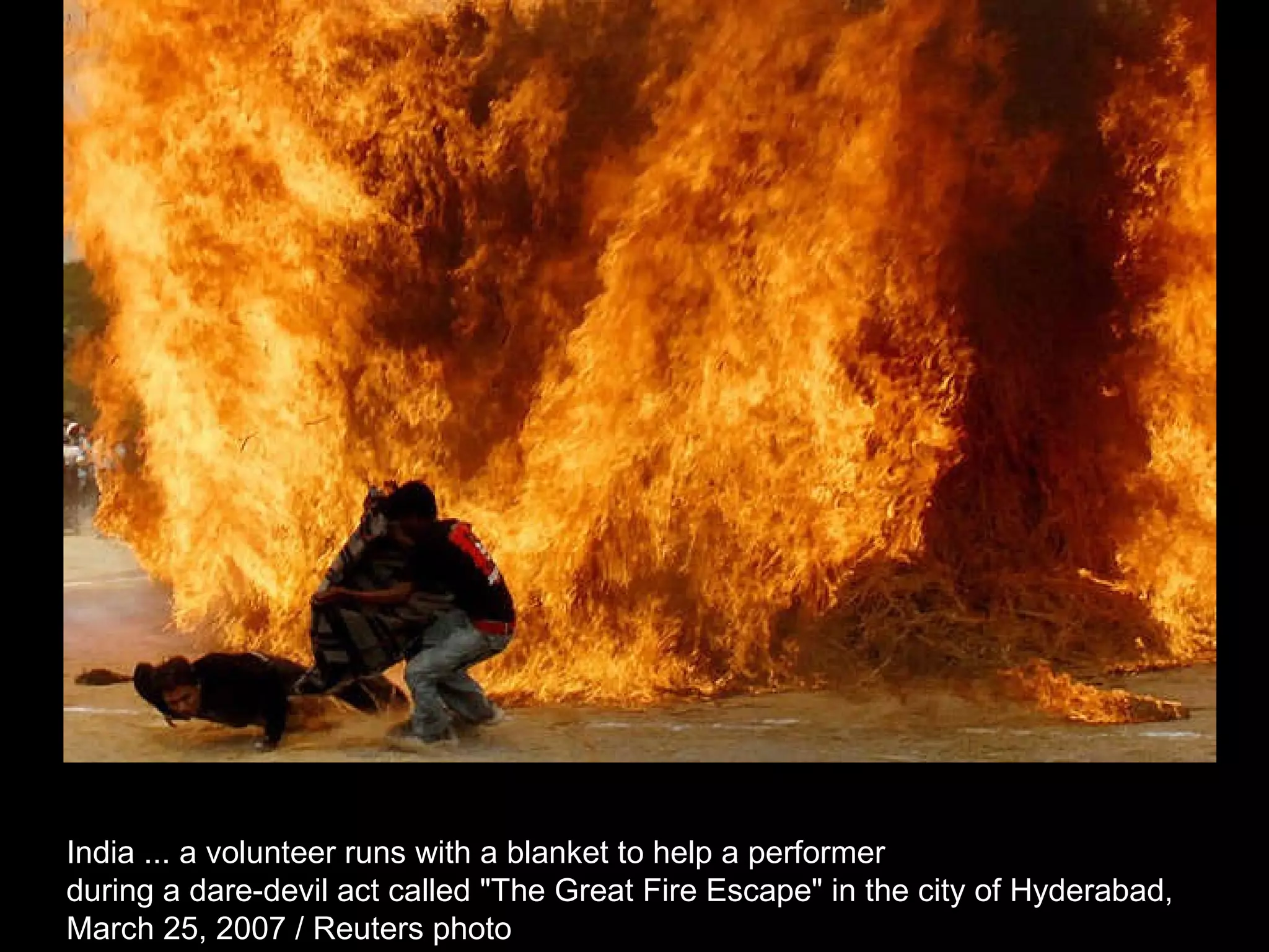 India ... a volunteer runs with a blanket to help a performer  during a dare-devil act called &quot;The Great Fire Escape&quot; in the city of Hyderabad,  March 25, 2007 / Reuters photo  