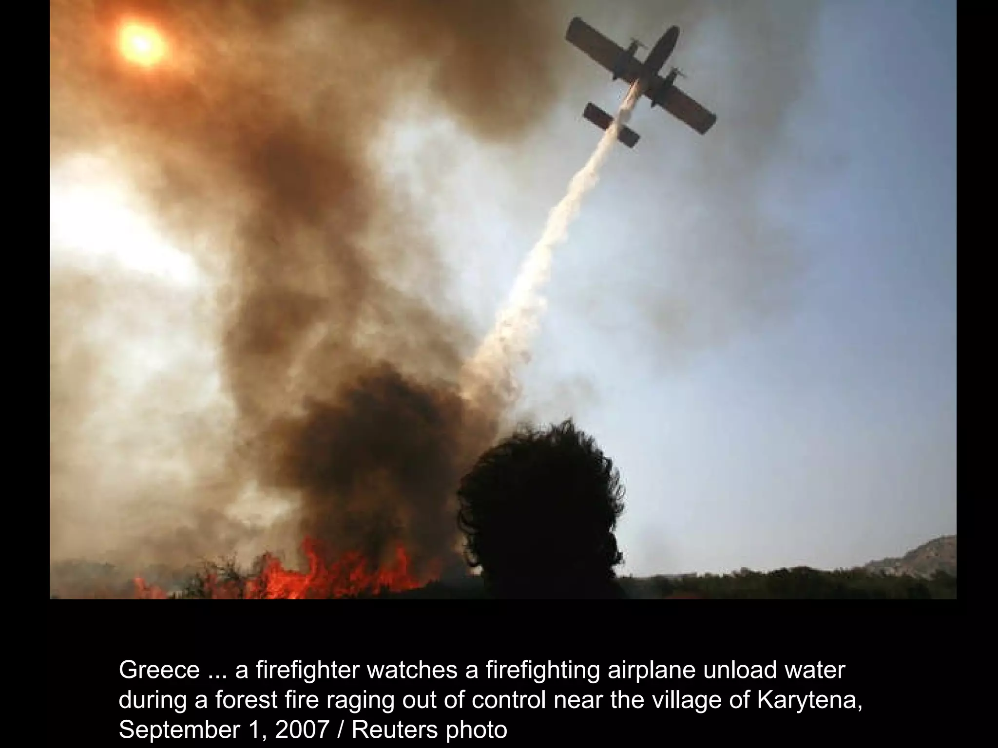 Greece ... a firefighter watches a firefighting airplane unload water  during a forest fire raging out of control near the village of Karytena,  September 1, 2007 / Reuters photo  