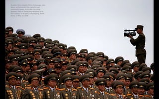 A solider films military officers following a mass
dance performance in the capital's main
ceremonial square, a day after ...