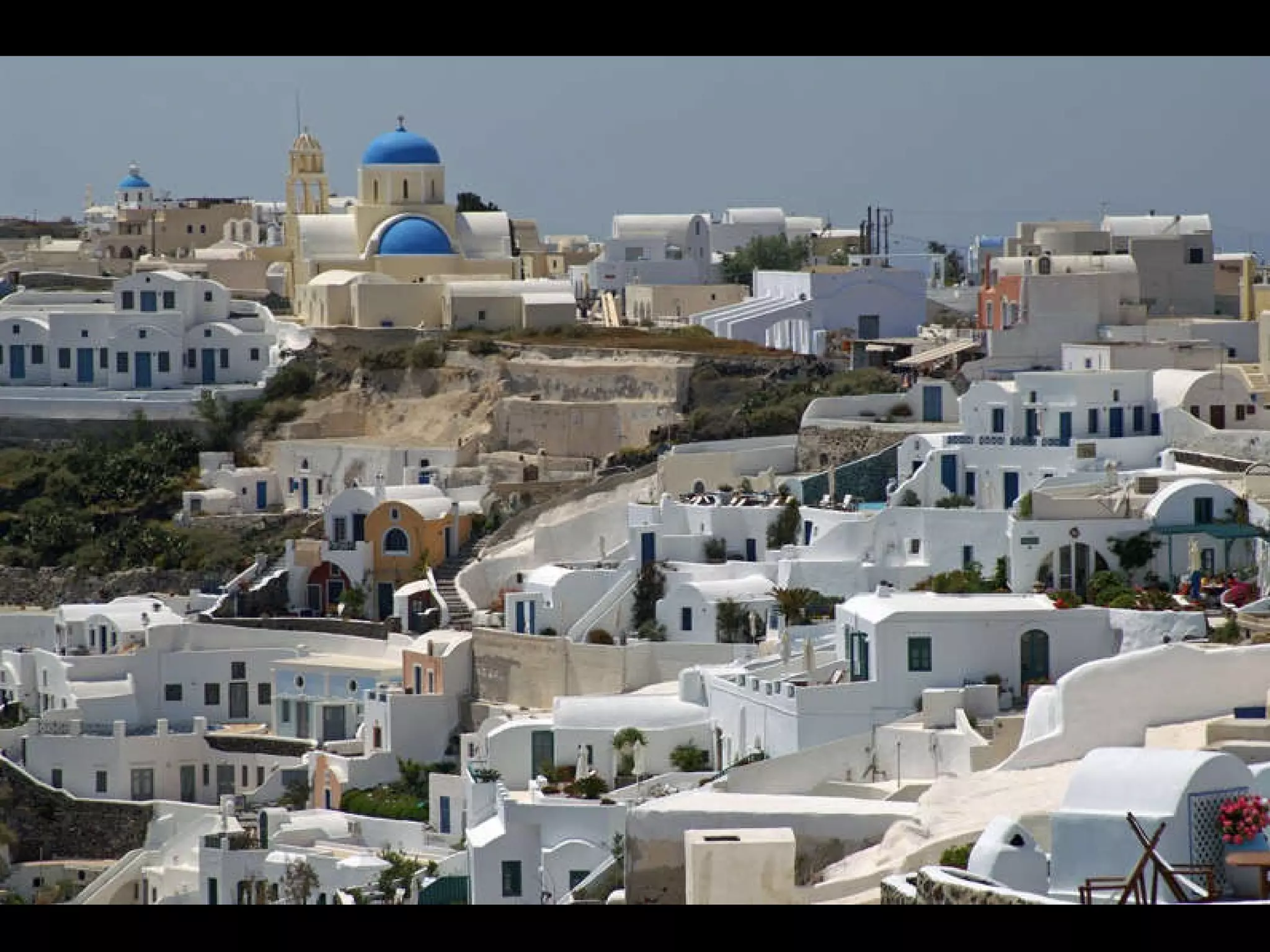 INFORMATION ABOUT SANTORINI ISLAND Santorini or Thira is located in the southernmost point of Cyclades.  It is a popular island, with intense night life that attracts thousands of visitors each year. The capital of the island is Fira.  Oia is one of the most popular settlements of Santorini. Thousands of people are visiting Oia in order to see the impressive sunset and the unique view.  The inhabitants of the island are almost 7.000 shared in 10 villages of the island. Most beaches of Santorini have volcano rocks giving the sense of “black” colour. The island is surrounded by abrupt precipices giving a particular physiognomy. The island has a wealth of archaeology that includes the ancient city at Mesa Vouno and the prehistoric settlement at Akrotiri. Santorini’s cultural includes a unique vernacular architecture, best exemplified by the settlements at Vothonas, Messaria, Finikia, and Megalohori and the advanced fortified settlements at Pyrgos, Emporio, and Akrotiri. The island’s moderate climate is due to its exposure to northeasterly winds, while winters on the island are temperate with average temperatures in the region of 10oC. Rainy winters alternate with dry summers, and the fertile soil is ideal for the cultivation of vines and tomatoes. The island has meager freshwater resources and few wells.  Santorini offers air links to Mykonos, Rhodes, Iraklio (Crete), as well as Athens and Thessaloniki. By sea, it’s linked to Piraeus and Thessaloniki, with connections to Paros, Ios, Mykonos, Anafi, Naxos, Sikinos, Syros, Kimolos, Kithnos, Milos, Serifos, Sifnos, Tinos, Folegandros, Astypalaia, Karpathos, Diafani, Kassos, Rhodes, Halki, Iraklio (Crete), Skiathos, Skyros, and Volos. There’s also a hydrofoil connection to Rafina and all the above-mentioned islands. 