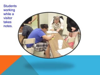 Students
working
while a
visitor
takes
notes.
 