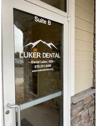 Signage on the glass page on the front door of Greeley dentist Luker Dental.pdf